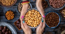 Zwei Personen halten eine Schale mit Cashewnüssen.